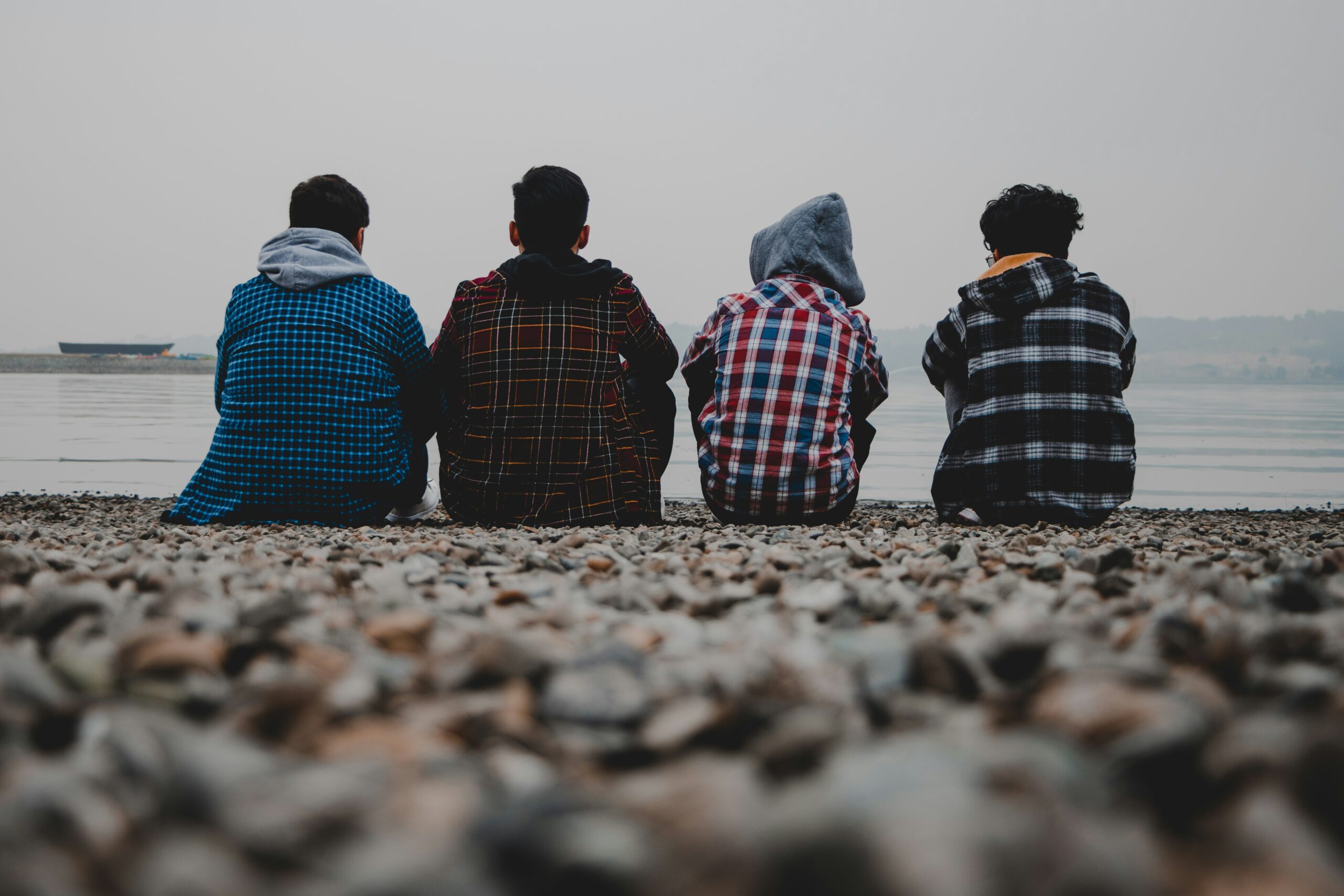 Young men sitting on a beach